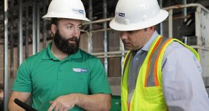 Cloud Construction Software Curran Young Construction discusses the jobsite on an iPad.