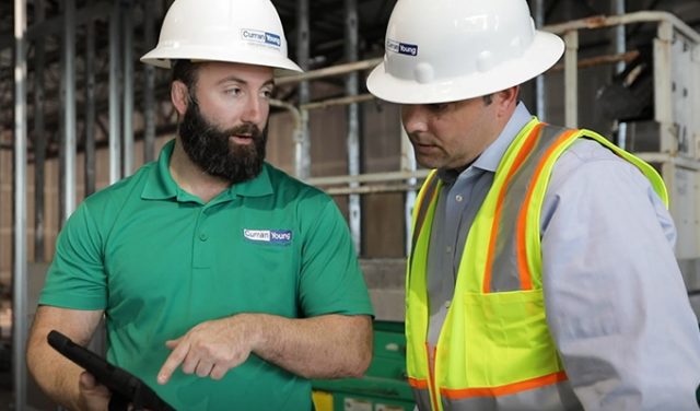 Curran_Young_on_Job_site Curran Young Construction discusses the jobsite on an iPad.