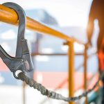 Construction worker wearing safety harness and safety line