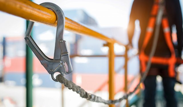 Construction worker wearing safety harness and safety line